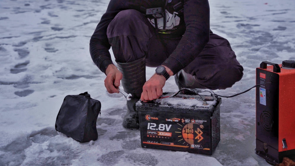 Angler connecting the LiThink battery on the ice