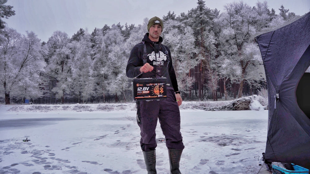 Winter angler with LiThink battery on a frozen lake
